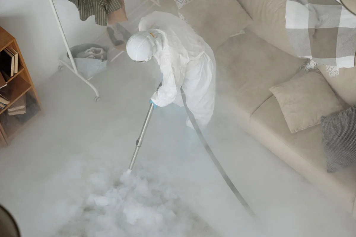 Biohazard cleanup technician in protective equipment, Pleasantville, IA